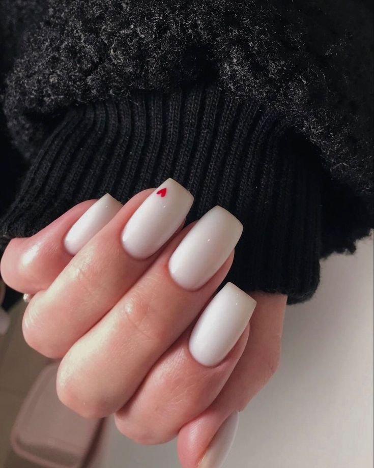 Chic Matte White Manicure with Subtle Red Heart Accent