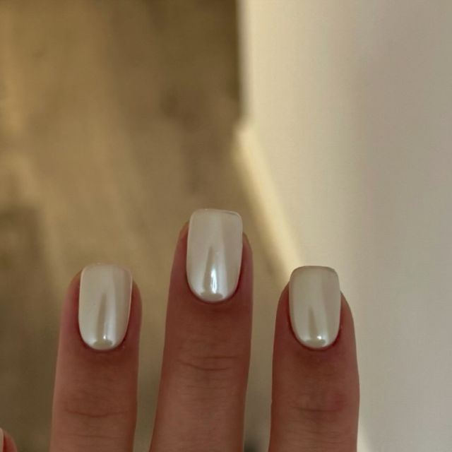 Sophisticated Elegant Glossy White Nails with Sleek Rectangular Shape and Subtle Pearl Finish.