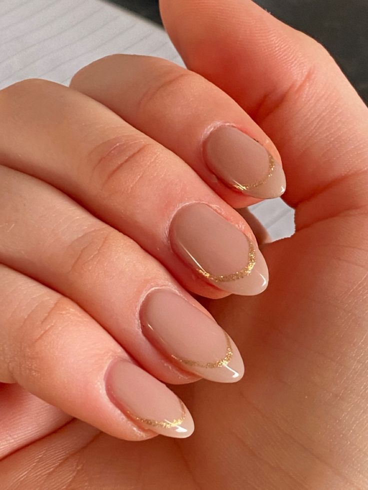 Chic Almond-Shaped Nude Nails with Delicate Golden Tips for Elegant Occasions