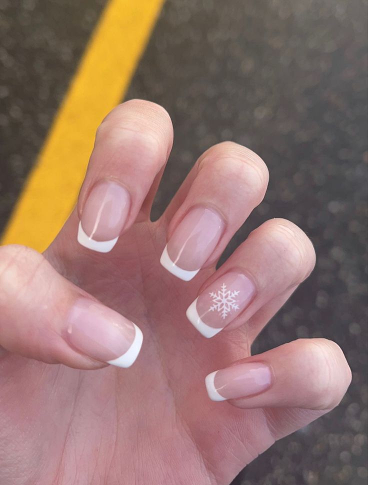 Sophisticated Winter French Tip Manicure with Delicate Snowflake Accent