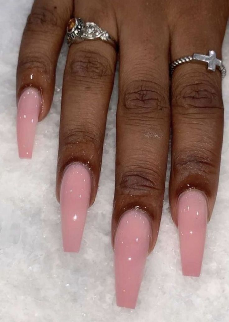 Chic Soft Pink Glossy Nails: Elegant Long Square Design Complemented by Delicate Rings.