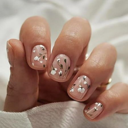 Elegant Floral Nail Art: Intricate White Blossoms on a Soft Pastel Canvas.