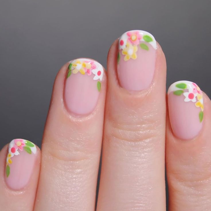 Charming Floral Nail Design with Soft Pink Base and Delicate Accents for Spring/Summer.