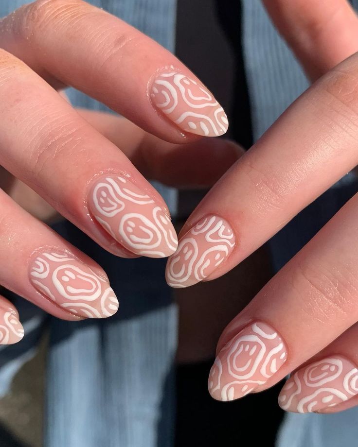 Modern Abstract Nail Design: Nude Base with White Patterns for a Chic Look.