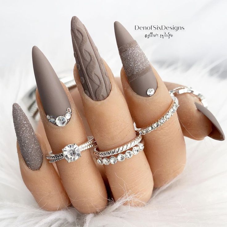 Chic Brown Nail Design: Matte and Textured Finishes with Sparkling Accents and Intricate Patterns.