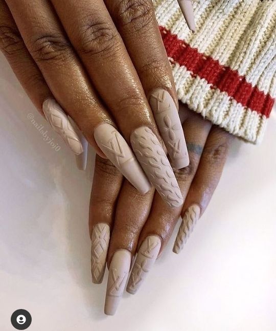 Elegant Beige Nail Design with Intricate Textures and Unique Detailing.