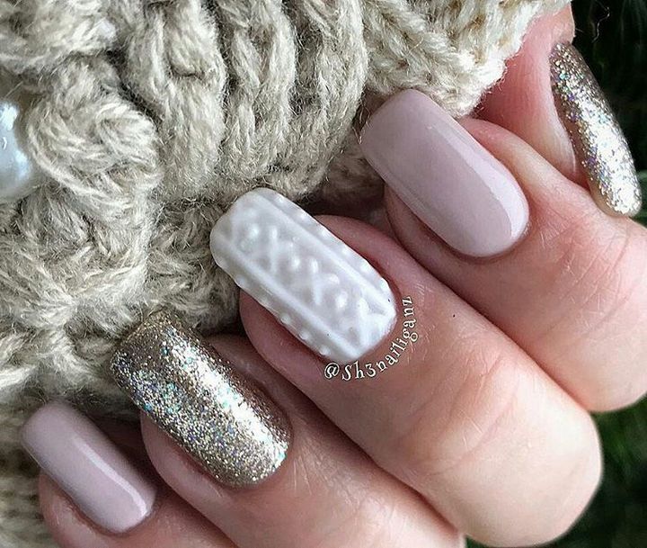 Sophisticated Festive Nail Design: Soft Beige and Shimmering Gold with Textured White Accent.