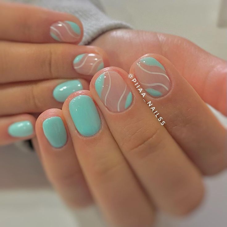 Chic Soft Turquoise Nail Design: A Playful Blend of Solid and Patterned Elegance.