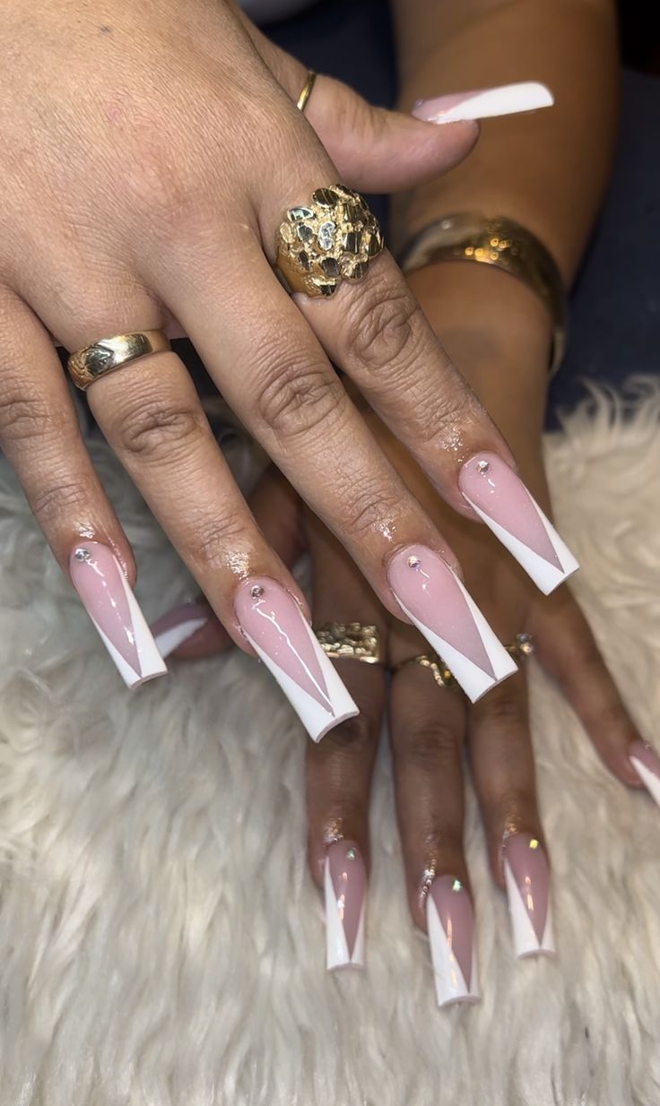 Modern Chic Nail Design: Elongated Rectangles with Soft Pink Base, Bold White Tips, and Elegant Gem Accents.