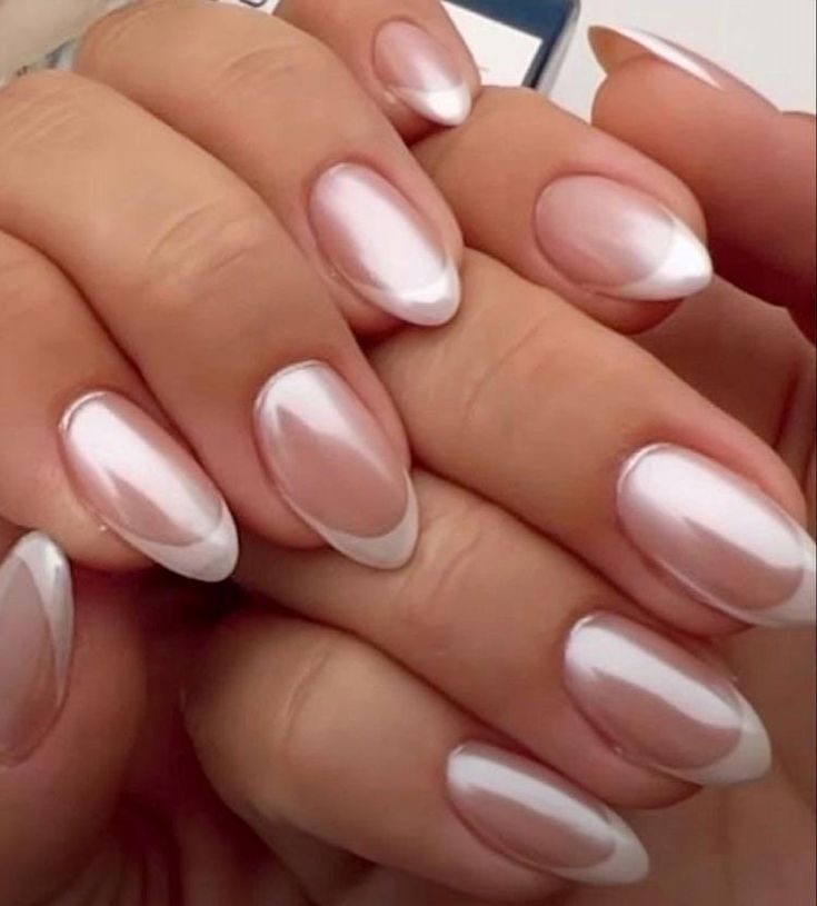 Sophisticated Elegance: Nude and Pearly White Gradient Nail Design with Classic French Tips.