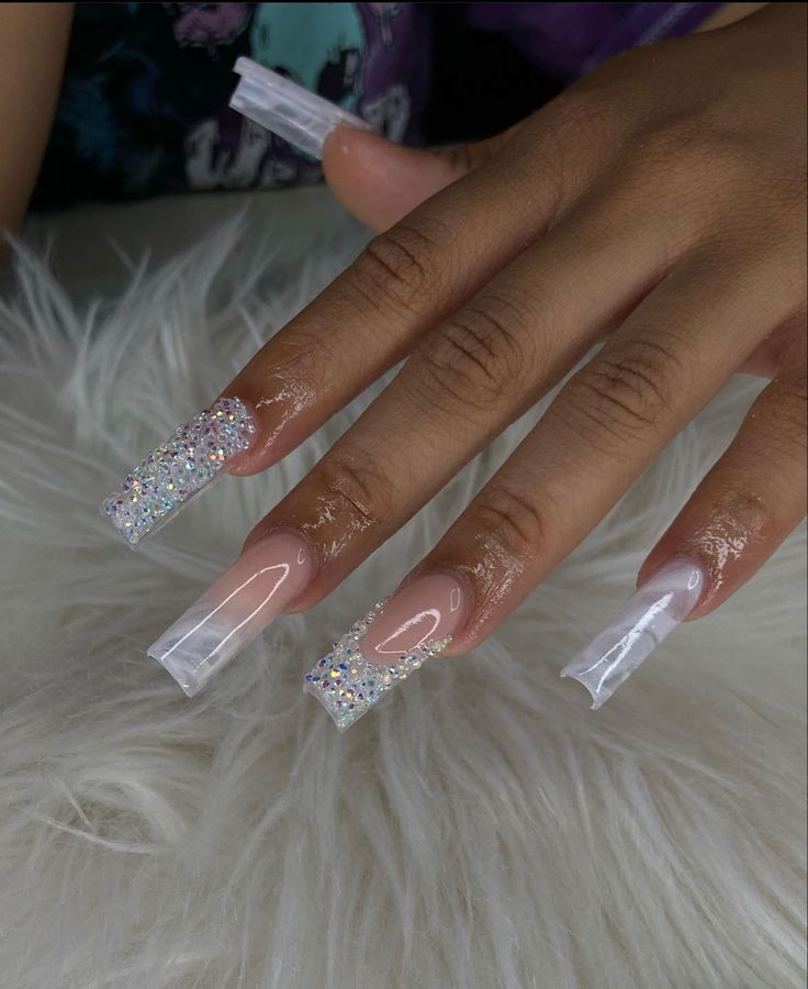 Elegant Nail Design with Shiny Acrylic Tips and Sparkling Embellishments.