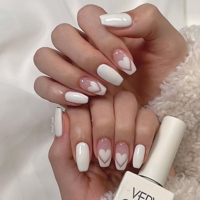 Charming Elegant Nail Design: Classic White with Subtle Heart Motifs