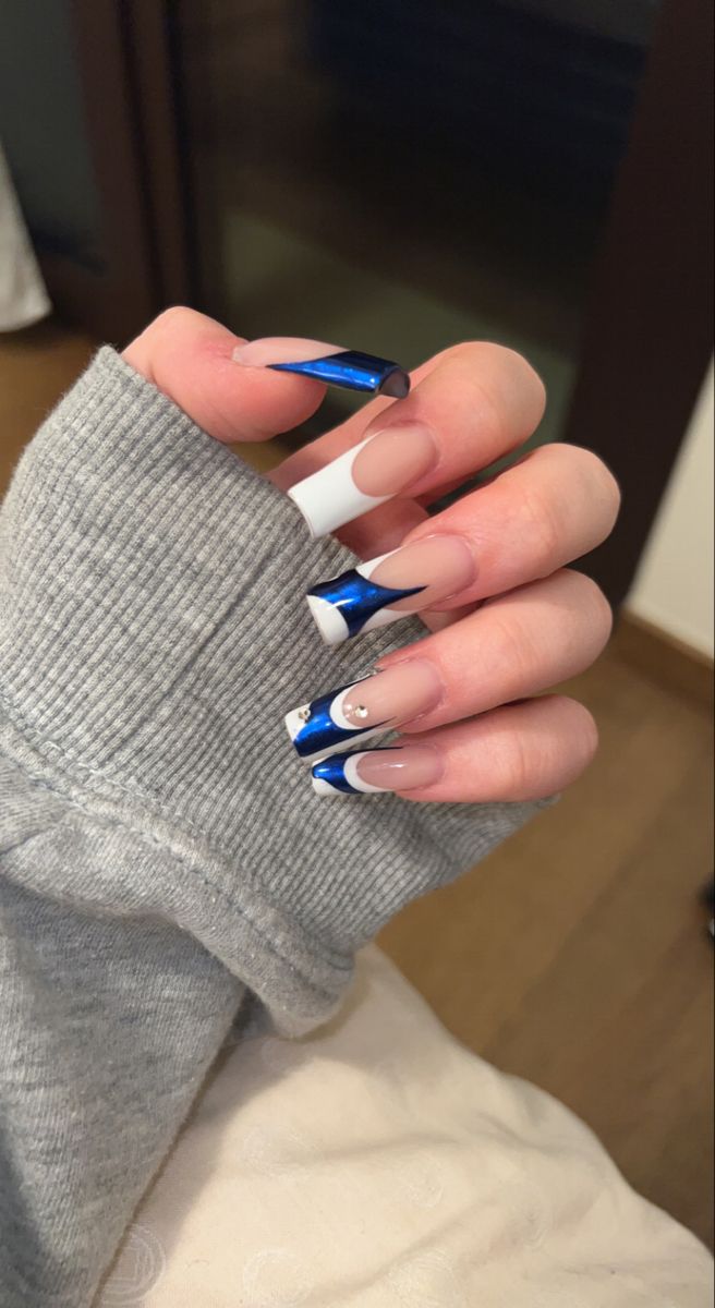 Chic Nail Design: Glamorous Blue and White French Tips with Shimmering Accents.