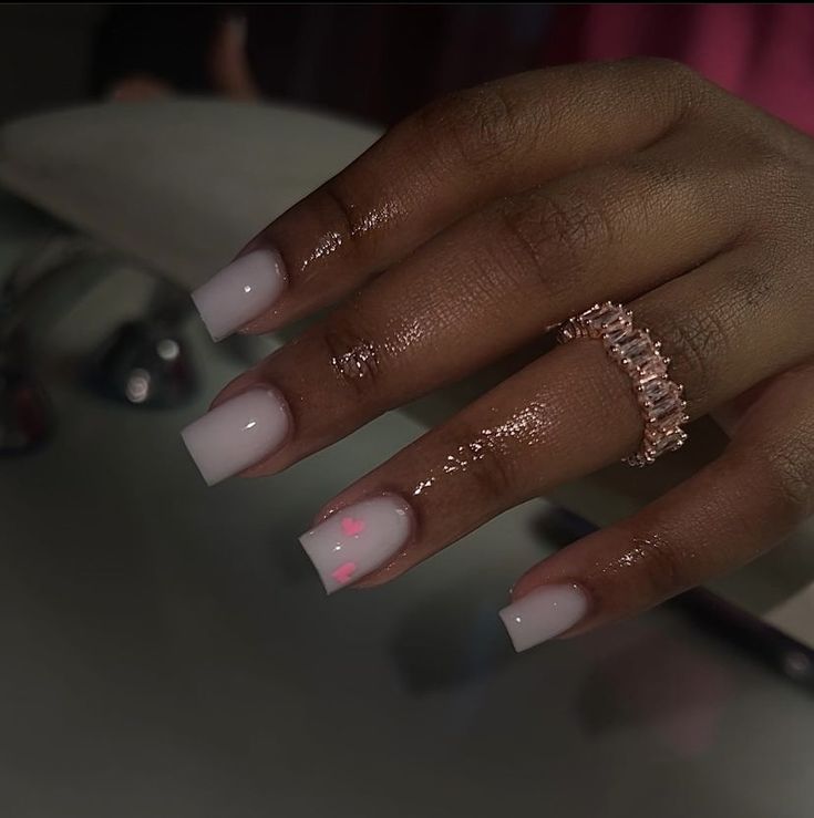 Chic Light Pink Square Nails with Metallic Accents and Delicate Ring.