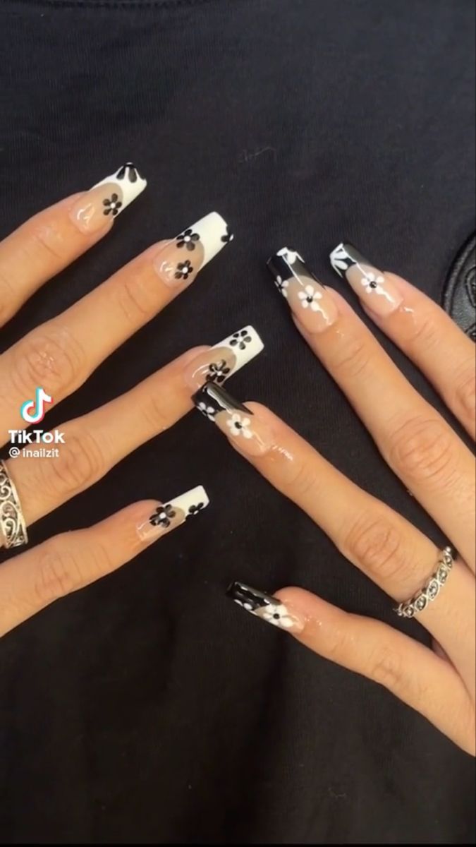 Chic Black and White Floral Nail Design: A Modern Twist on Classic French Manicure.