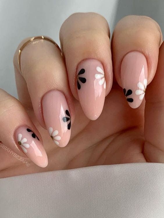 Elegant Oval Floral Nail Design with Soft Pink Base and Charming Black-and-White Motifs.