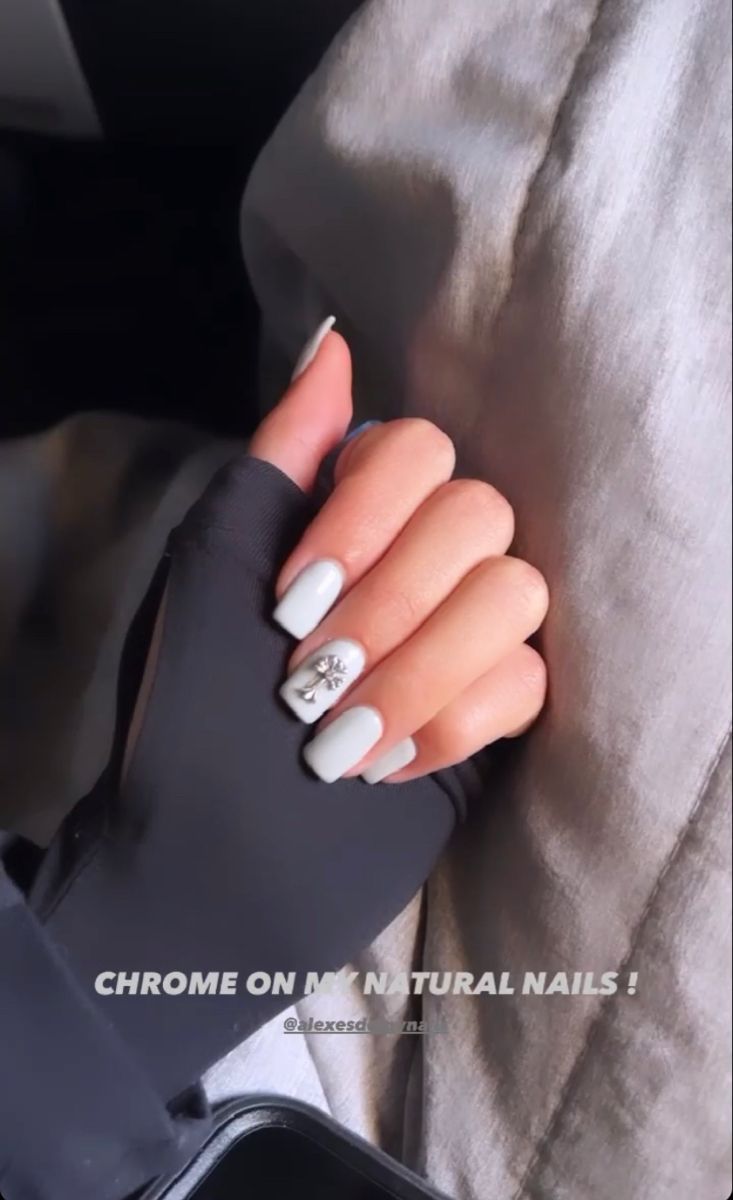 Chic Chrome-Finished Nail Design with Soft Pastels and Unique Embellishments.