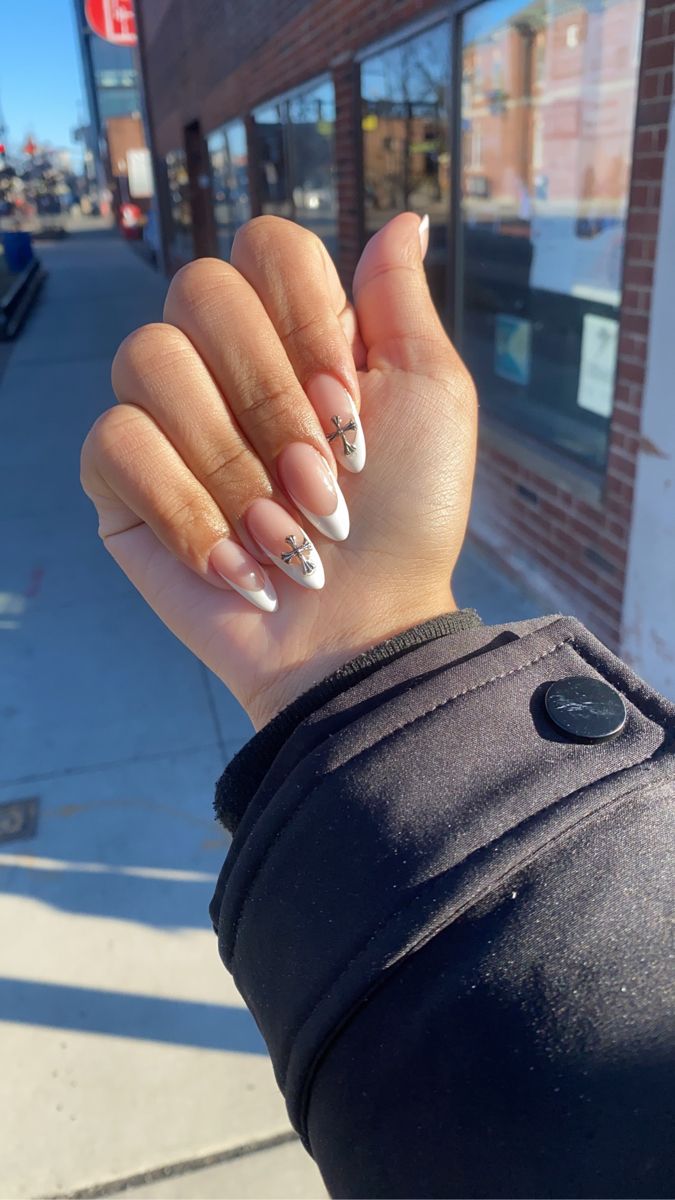 Chic Almond-Shaped Nails: Soft Nude Base, White Tips, and Delicate Silver Accents.