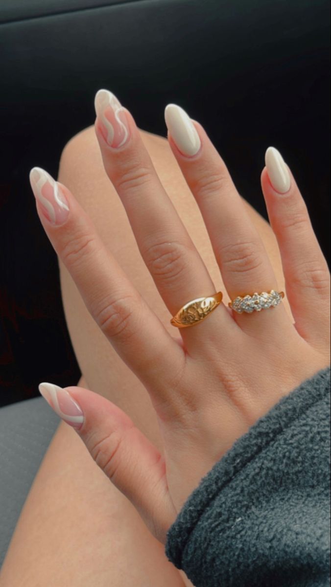 Chic White Nail Design with Wavy Accents and Minimalist Jewelry for a Refined Look.