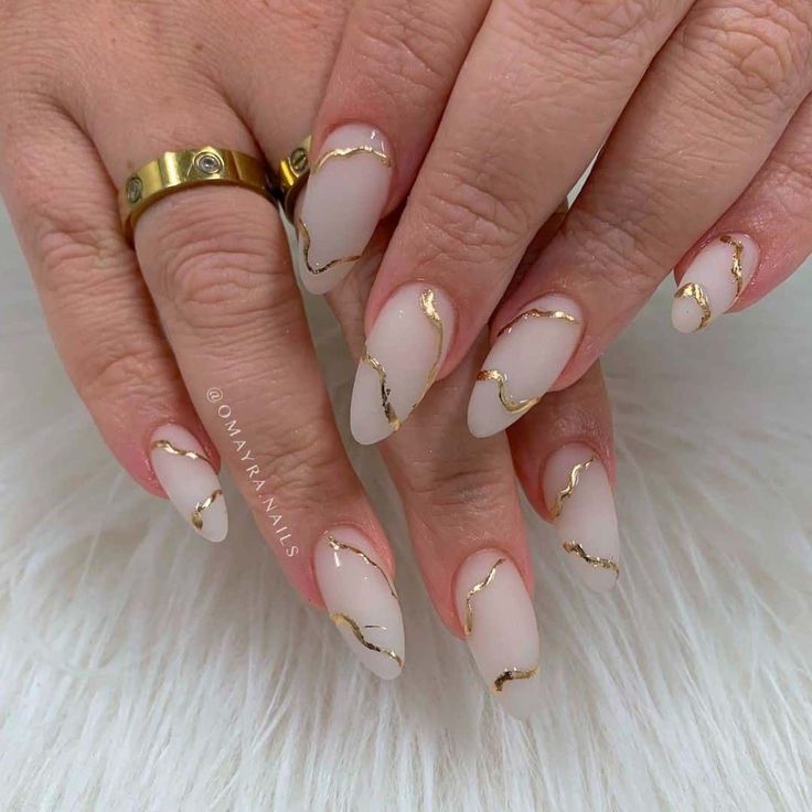 Chic Glossy Nude Nails with Delicate Gold Art for Any Occasion.