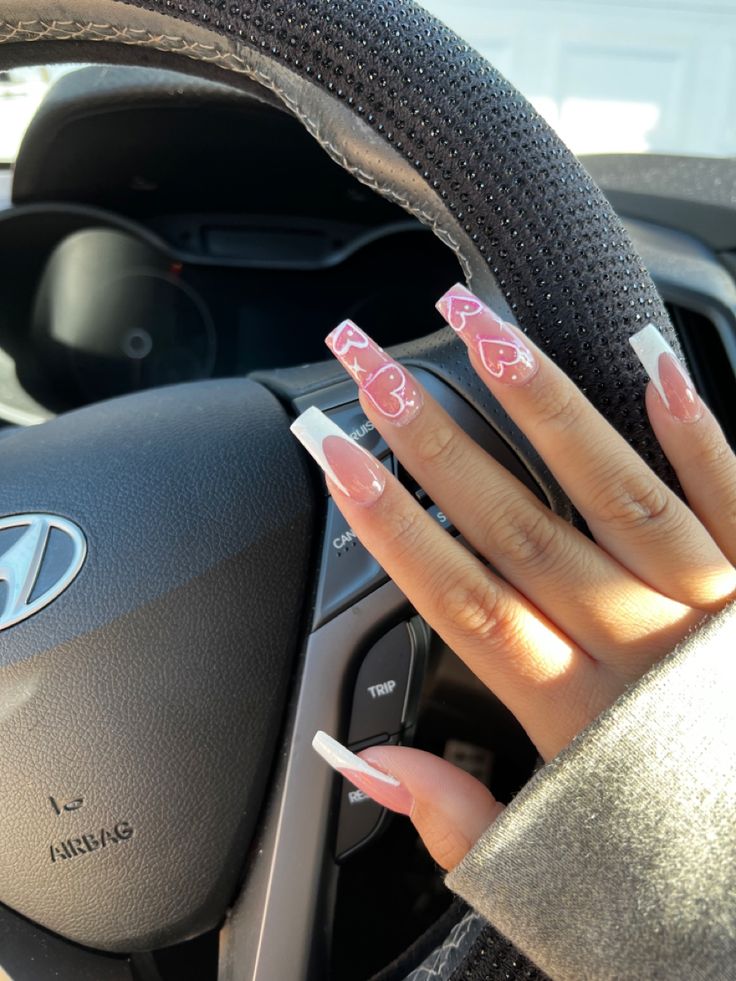 Trendy Long Nails: Playful Nude and Pink Heart Motif Design