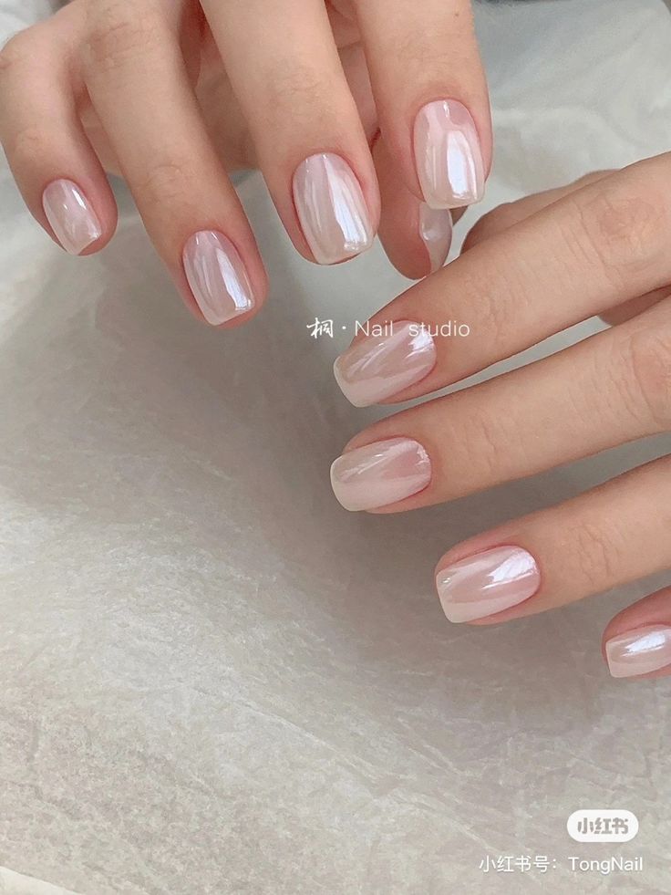 Chic Minimalist Nail Design: Glossy Pink Hues with Solid and Gradient Styles.