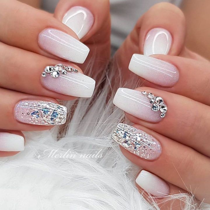 Elegant French Tip Nail Design with Sparkling Rhinestones and Gradient Effect