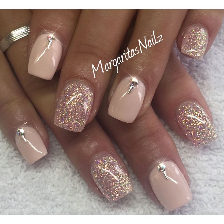 Chic Elegant Nude and Glitter Nail Design with Dazzling Accents and Rhinestones.