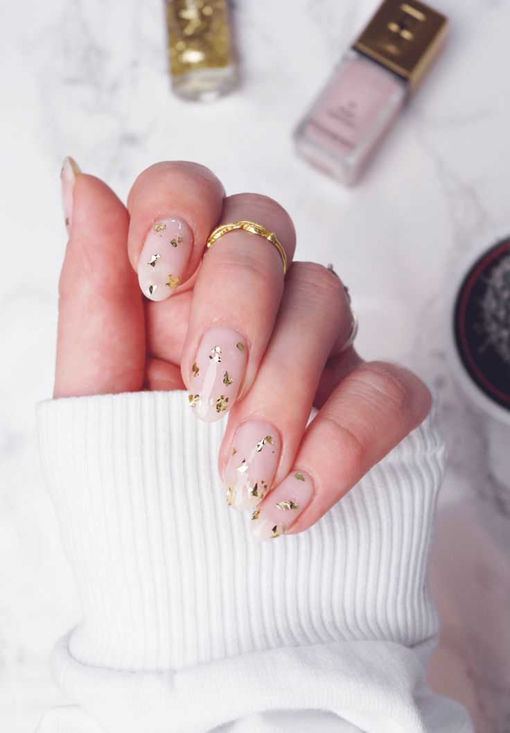 Elegant Nude Nail Design with Gold Foil Accents for a Touch of Glamour.