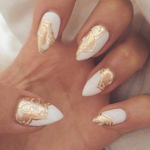 Chic Almond-Shaped Nail Design with White Polish and Gold Foil Accents