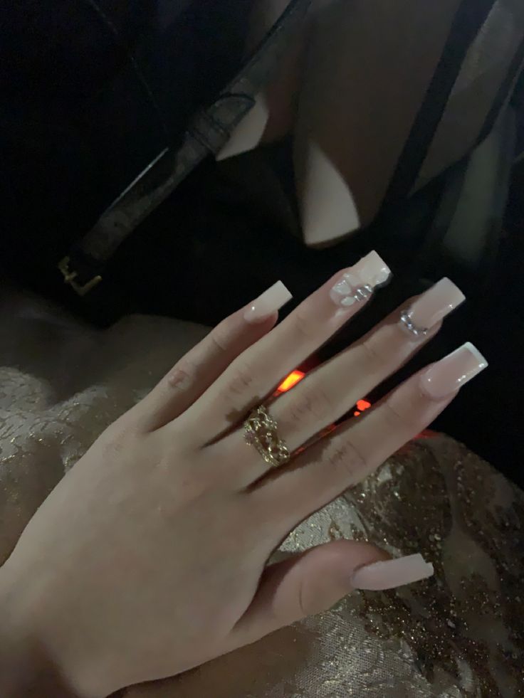 Chic Glossy Long Nails with Elegant Marble Art and Stunning Ring Accents.