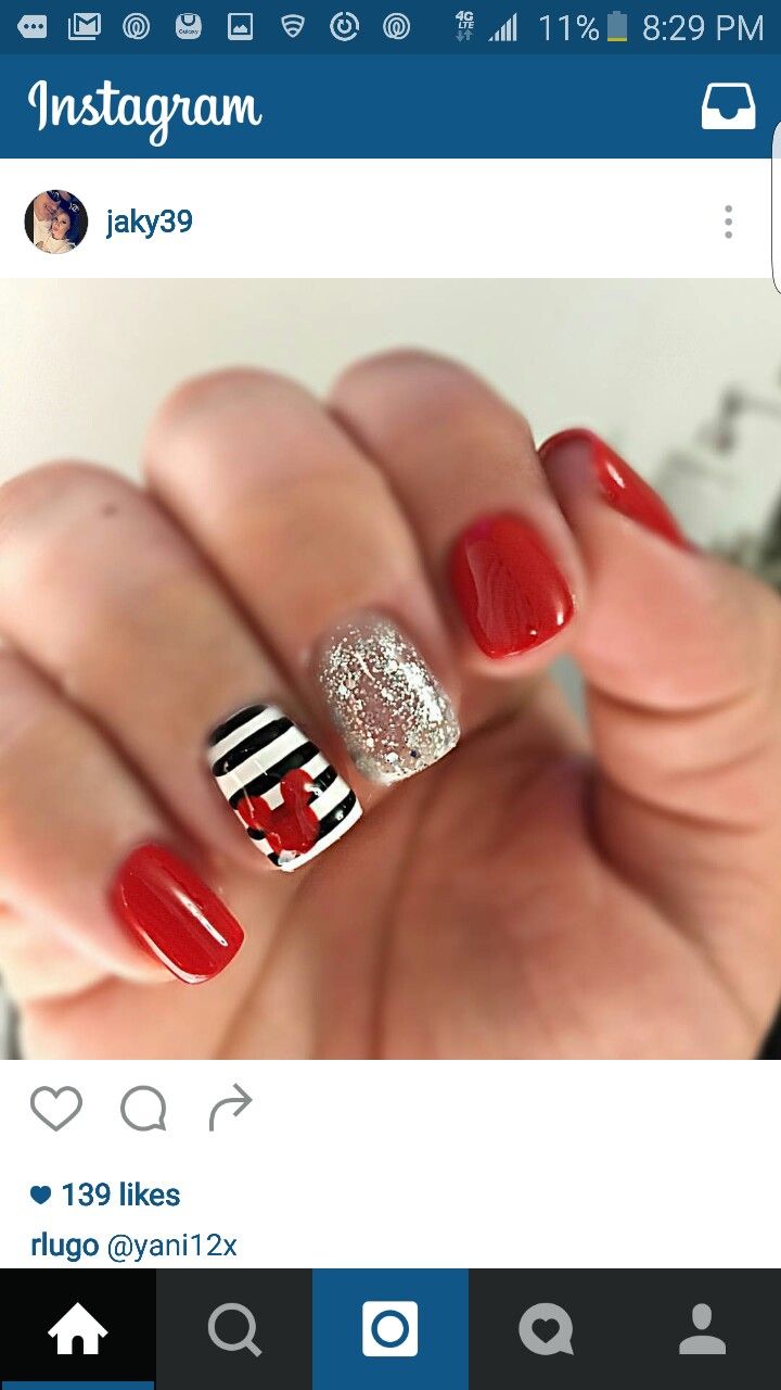 Festive Vibrant Red Nail Design with Silver Glitter and Playful Patterns