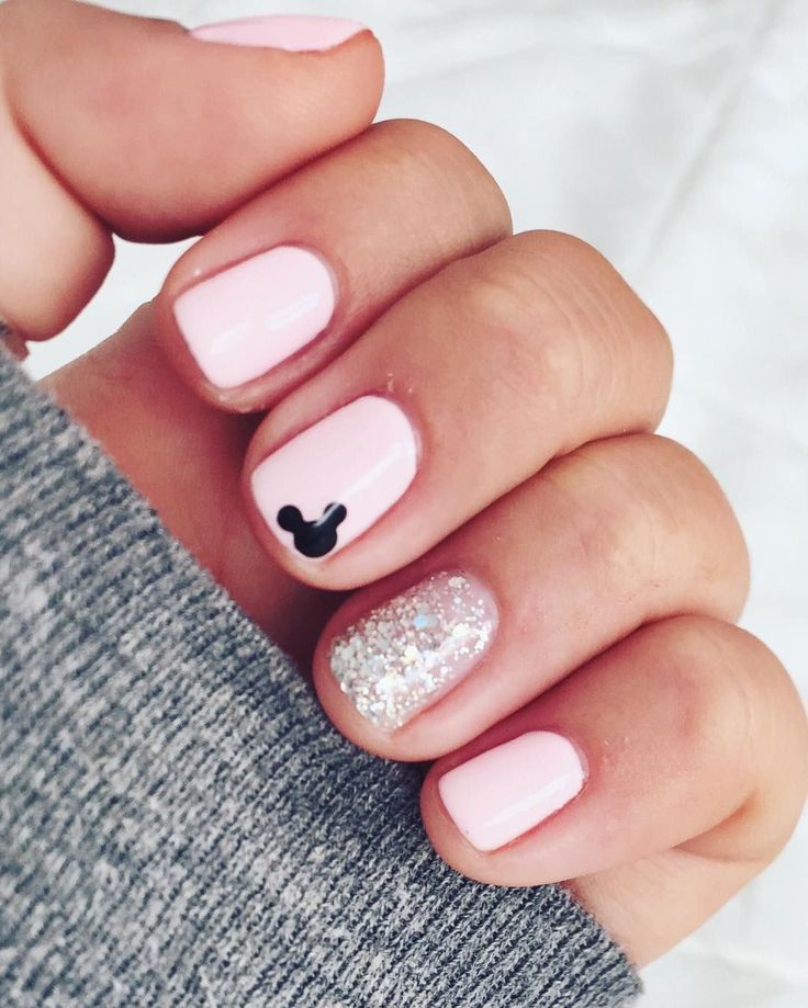 Whimsical Disney-Inspired Nail Design: Soft Pink Base with Black Mickey Mouse and Glitter Accent