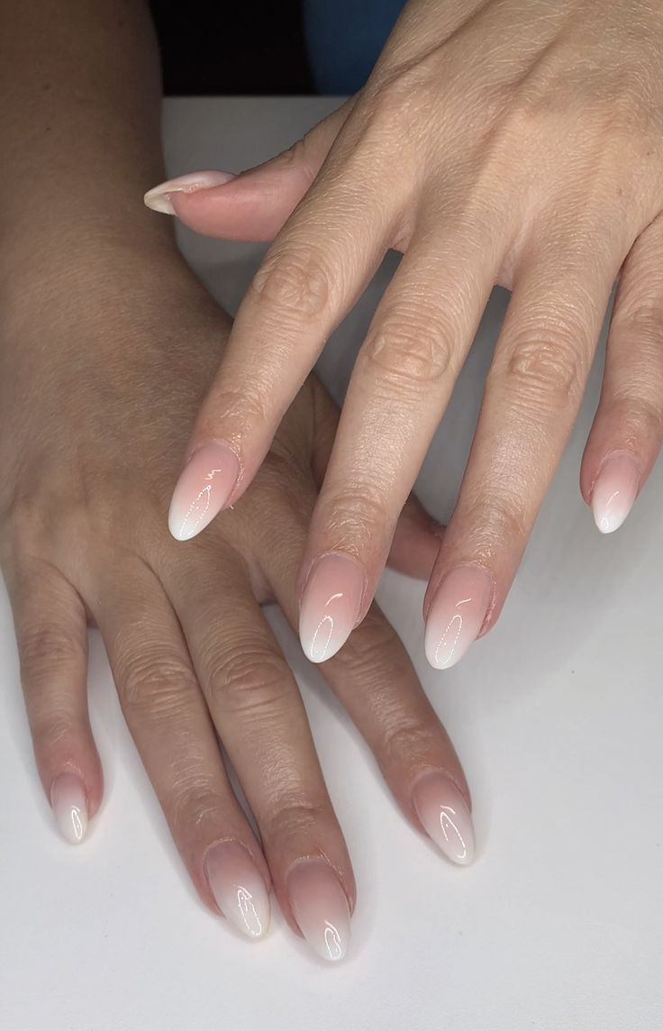 Sophisticated Oval-Shaped Gradient Nails: Delicate Pink to White Design for Any Occasion