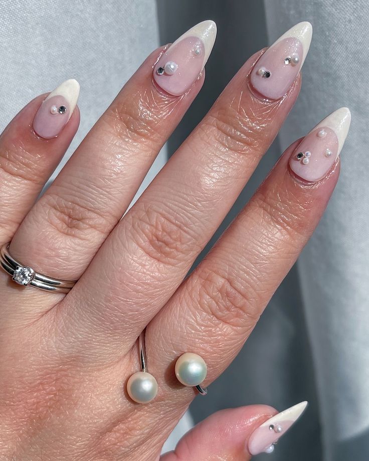 Chic Ombre Nail Design with Gems and Pearls for a Modern Look.