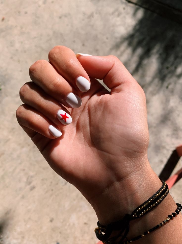 Modern White Nail Design with Bold Red Star Accent for Versatile Occasions.