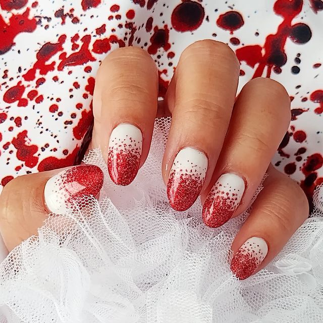 Bold Red and White Glitter Gradient Nail Design with Artistic Flair.