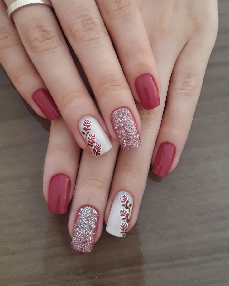 Elegant Burgundy and White Nail Design with Rose Patterns and Glitter Finish.