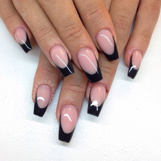 Chic Almond-Shaped Nails: Elegant Pale Pink Base with Bold Black Tips for a Trendy Look.