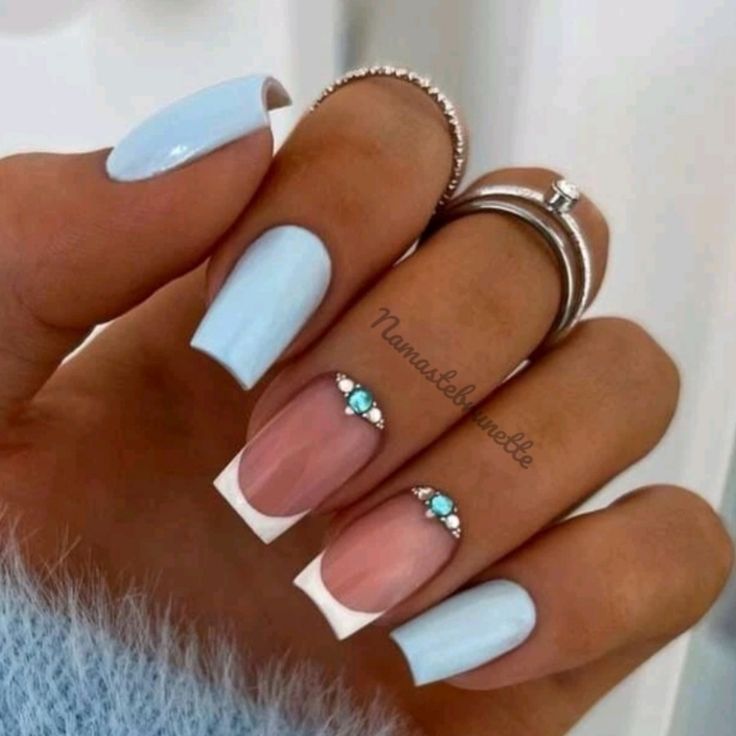 Elegant Nail Design with Pastel Blue, French Tips, and Gemstone Accents.