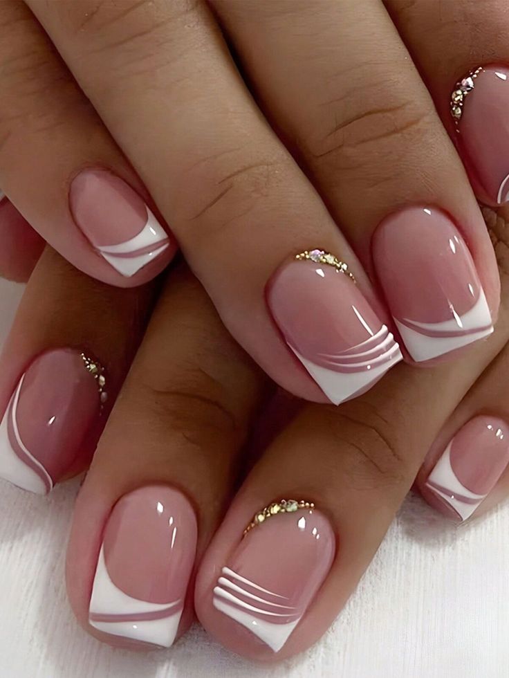 Elegant Soft Pink and French Tip Nail Design with Subtle Gold Accents.