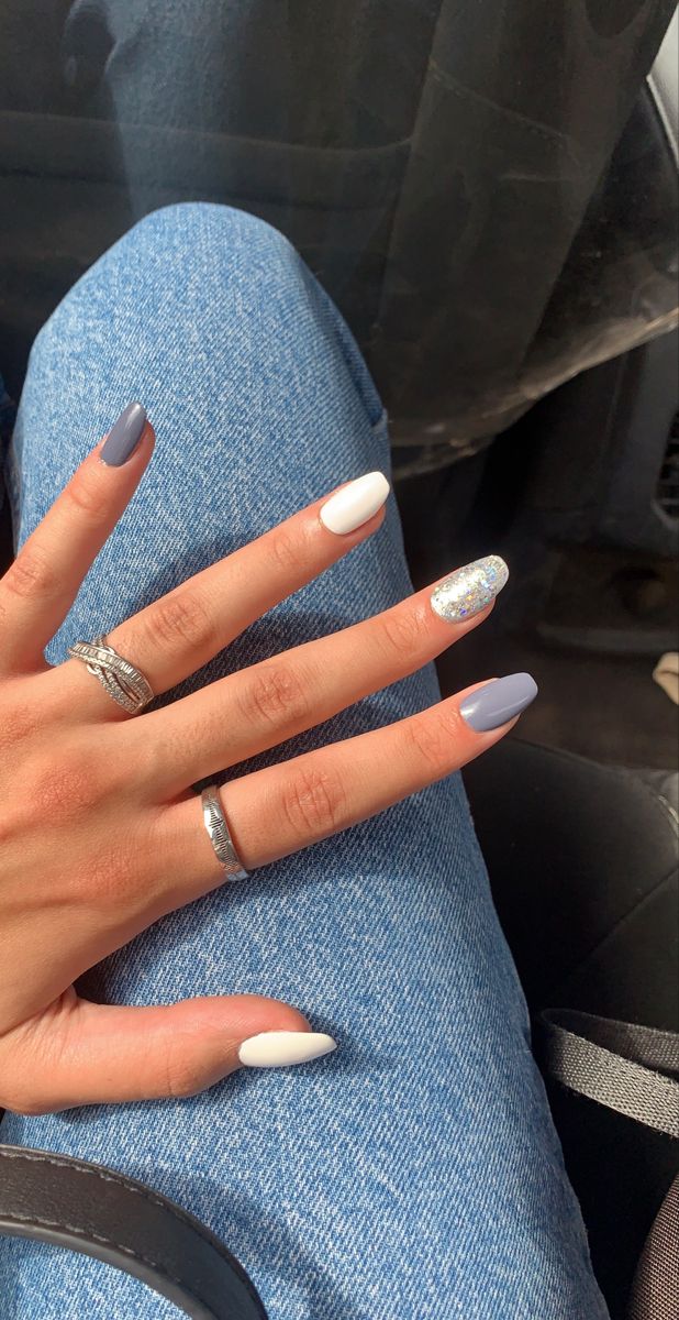 Elegant Almond-Shaped Nail Design with Sophisticated Gray and White Shades and a Playful Glitter Accent.