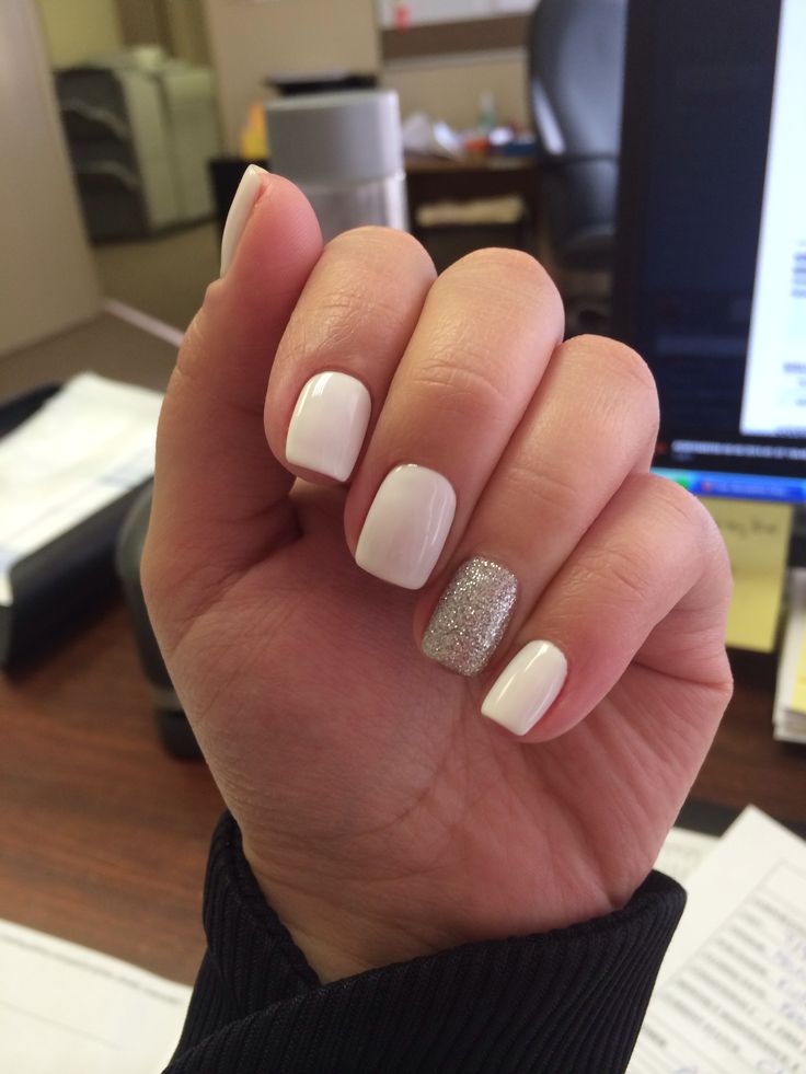 Sophisticated Nail Design: Pristine White with Striking Silver Glitter Accent.