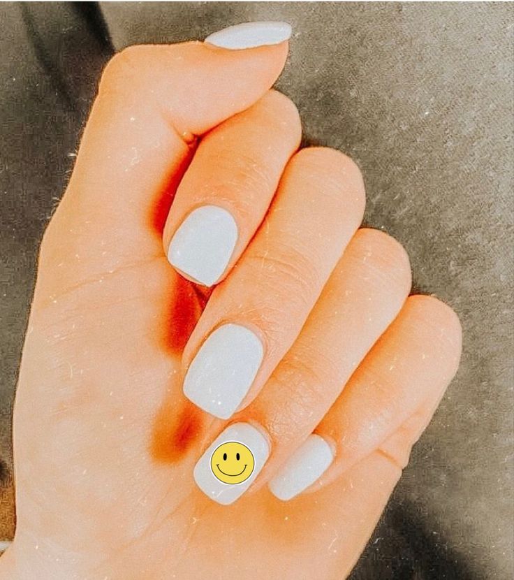 Tranquil Pastel Blue Nail Design with Playful Smiley Face Adds Whimsy.