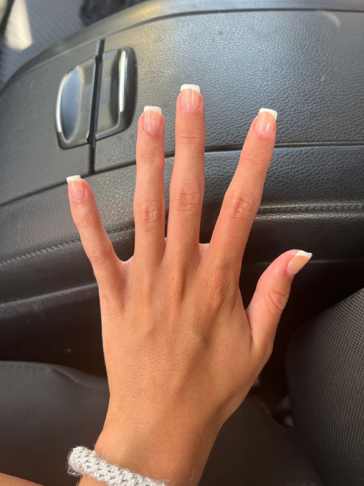 Timelessly Elegant French Tip Manicure: A Subtle Pink Base with Crisp White Tips