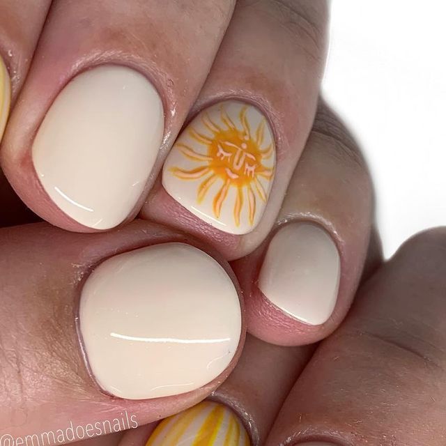 Cheerful Sun Motif Nail Design: Soft Neutral Base with Playful Yellow Accents