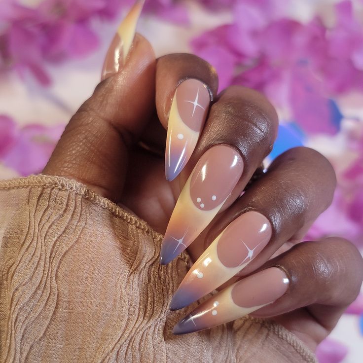 Elegant Gradient Nail Design with Elongated Tips and Starburst Accents.