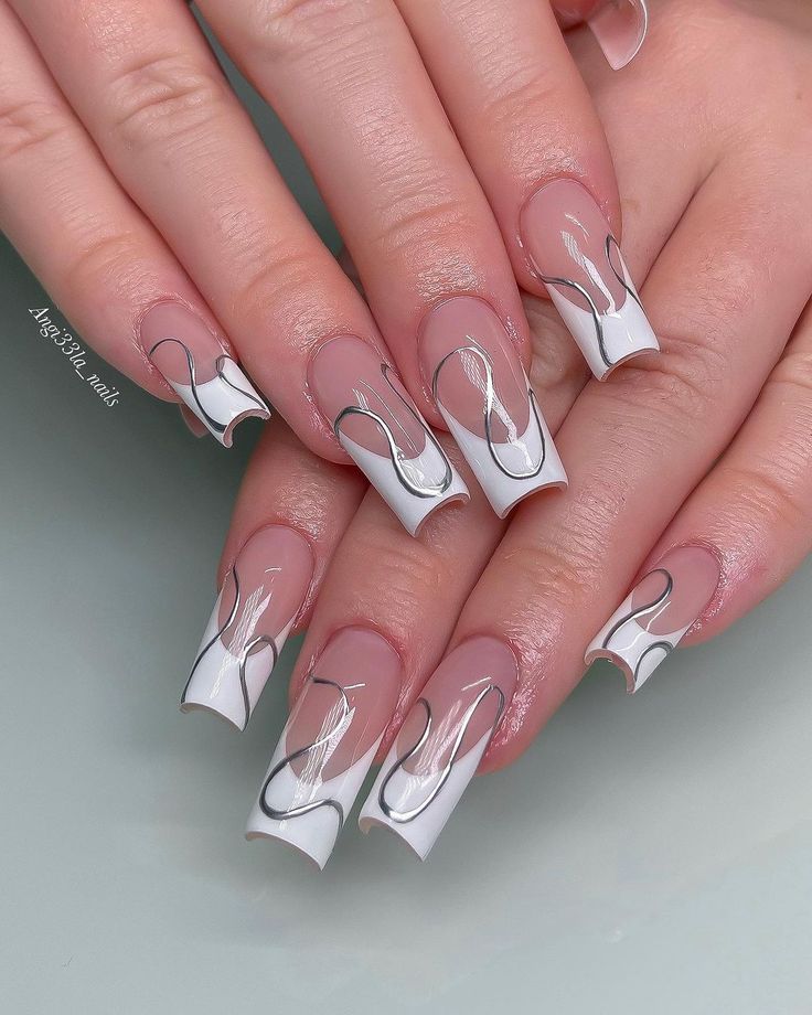 Chic Nail Design: Soft Nude and Striking White with Wavy Patterns and Silver Accents