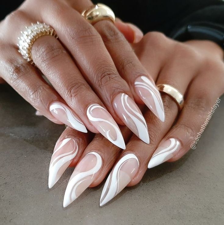 Sophisticated Almond-Shaped Nail Design with Elegant White Swirls on Nude Base.