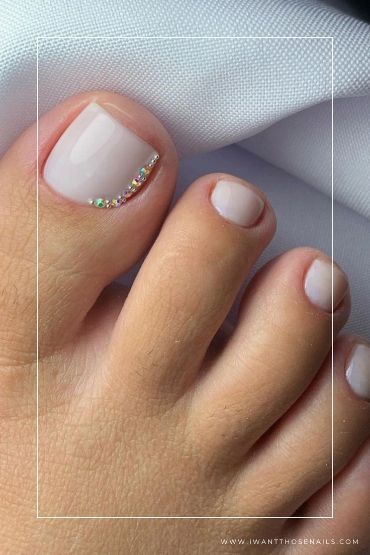 Sophisticated Nude Toe Nail Design with Elegant Rhinestone Accent